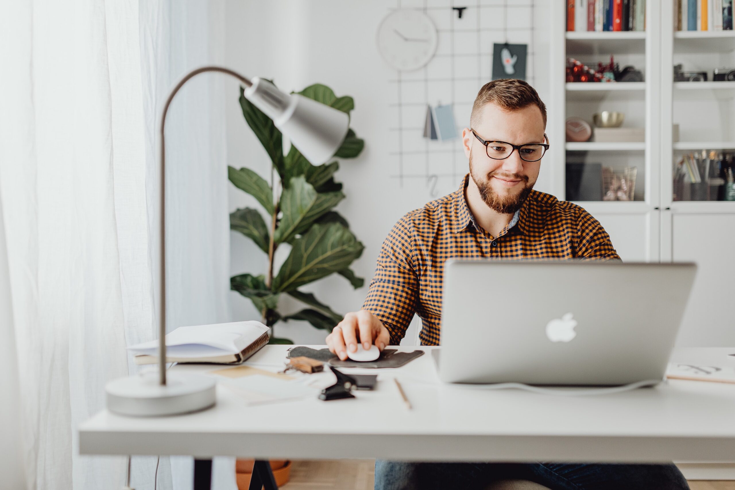 young male entrepreneur sitting at a desk with laptop