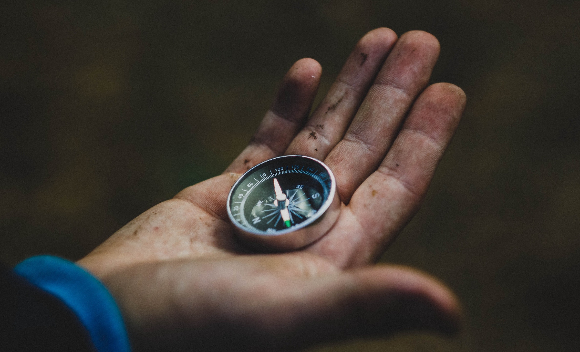 hand holding on older compass