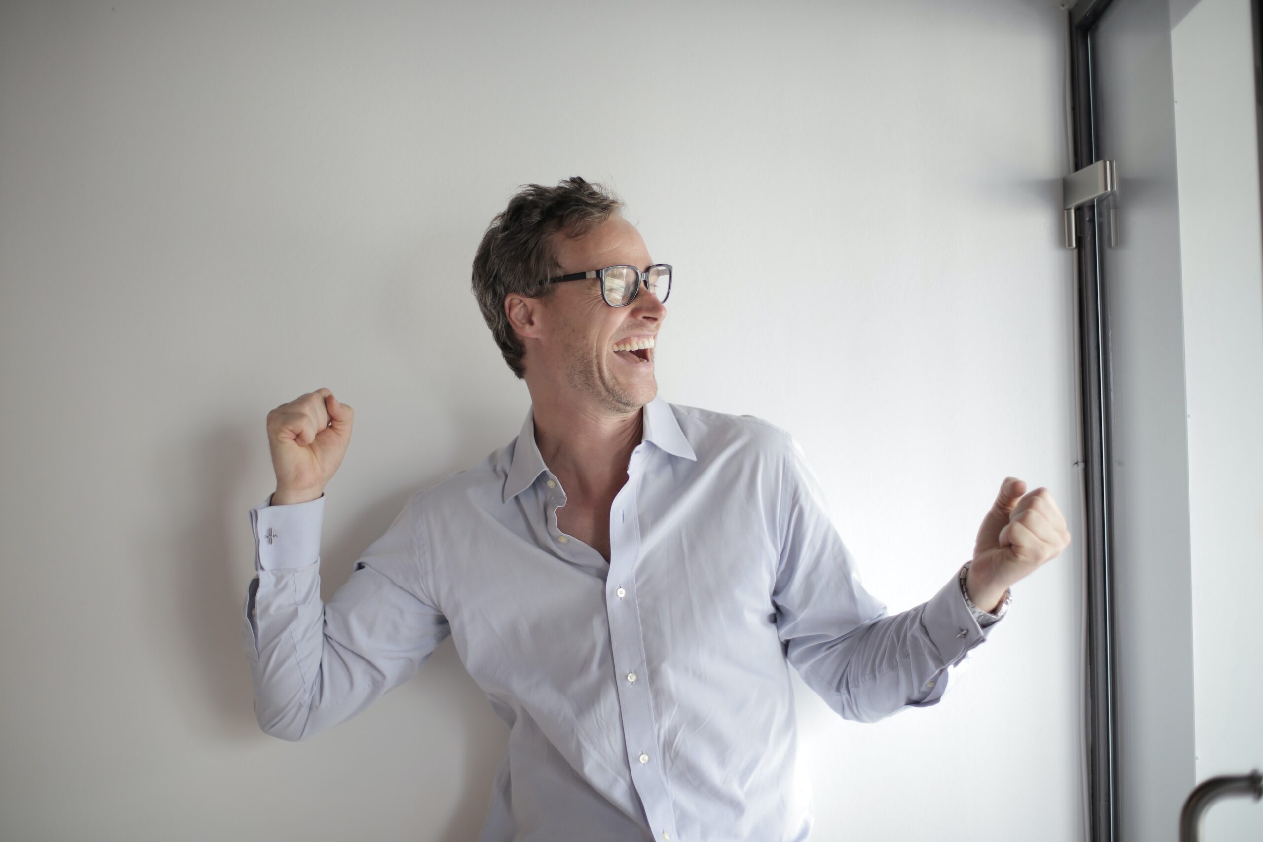 man in white long sleeved shirt celebrating