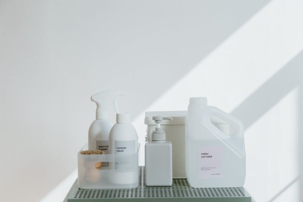 A bright white, cleanly branded line of cleaning supplies displayed on a simple table